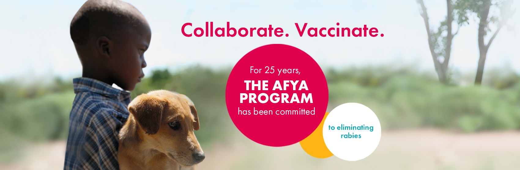 A boy and his dog in the Serengeti showing that for 25 years, The Afya Program has been committed to eliminating rabies.