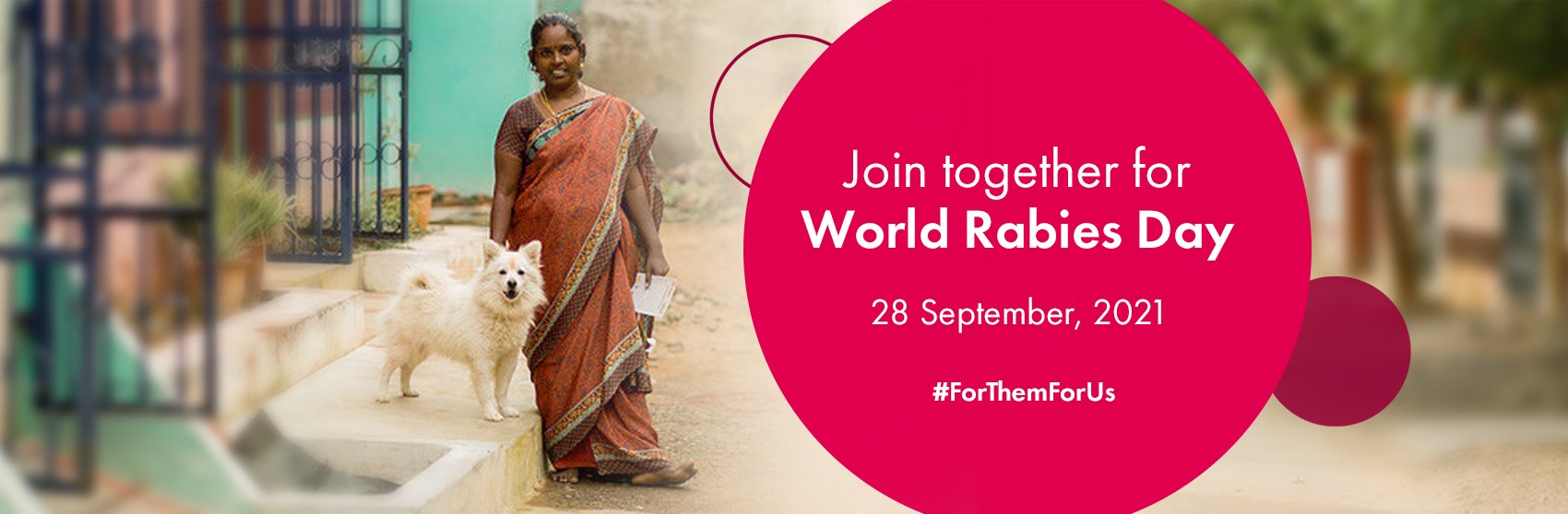 A woman stands with her dog to commemorate World Rabies Day.
