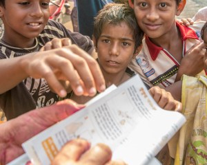 Volunteers hand out rabies vaccination forms to local people.